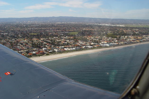 Flying by Henley Beach, with Adelaide, South Australia in the distance.