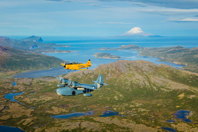 A great shot of Old Yaller in formation with a Grumman Goose along the coast of the Kenai Peninsula. Photo by Toby Harriman.
