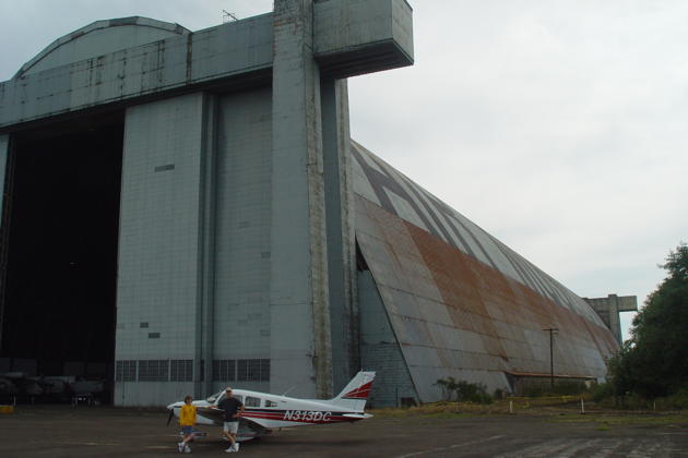 Parked with the Warrior next to the massive 1072-foot long blimp hangar at Tillamook, OR.