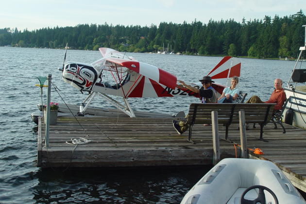 The Kitfox docked on Mercer Island, with Matthew and his neighbors Martha and Fred Weiss.