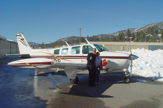 Jim Cummiskey and Mary alongside Jim's A36 Bonanza at Big Bear.