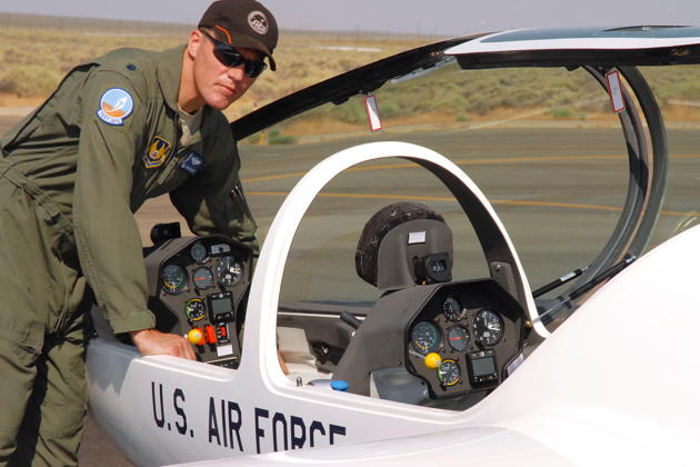 L/C Jason Schott with DG-1001 #1 at Edwards North Base. Jason and I flew the first AF acceptance flight together. Note the red guarded switches in the front cockpit for the smoke system. USAF Photo by Kenji Thuloweit.