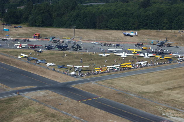 An overflight view of the warbirds and vintage aircraft gathered at taxiway Kilo-7 at Paine Field.