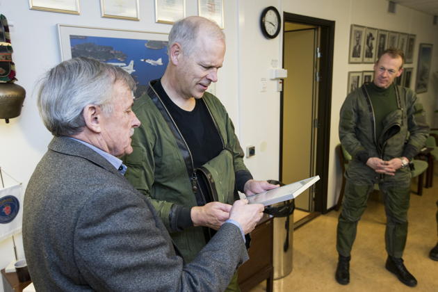 Reviewing 'The Gripen Order' with Stig Holmstrom, first Gripen pilot, with Richard Ljungberg looking on. Photo by Per Kustvik.