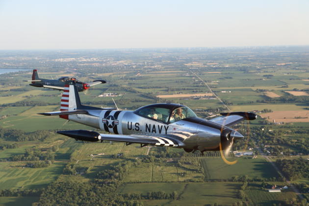 Greg Young and Dave Desmon flying formation in their Navions at Oshkosh.