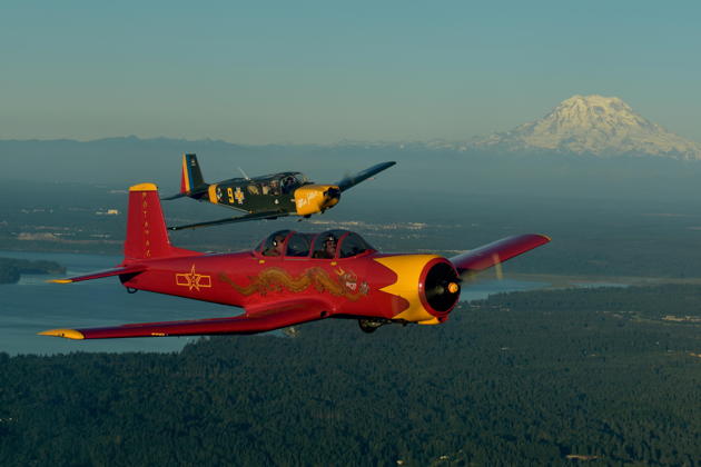 Tom Elliott in his Nanchang leading Bob Hill in his IAR-823 on a late afternoon flight with Mt. Rainier in the distance. Photo by Karyn 'SkyQueen' King.