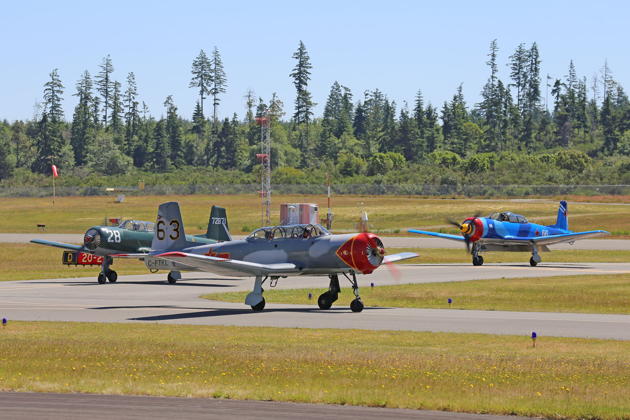 Taxiing in with the Nanchang flight at Bremerton, with Chris Walker and Dean 'Frito' Friedt in C-FTKL (63), Tom Gordon with me in N280NC (28), and Mike 'Mitch' Mitchell in C-FZAT (66). Photo by Dan Shoemaker.