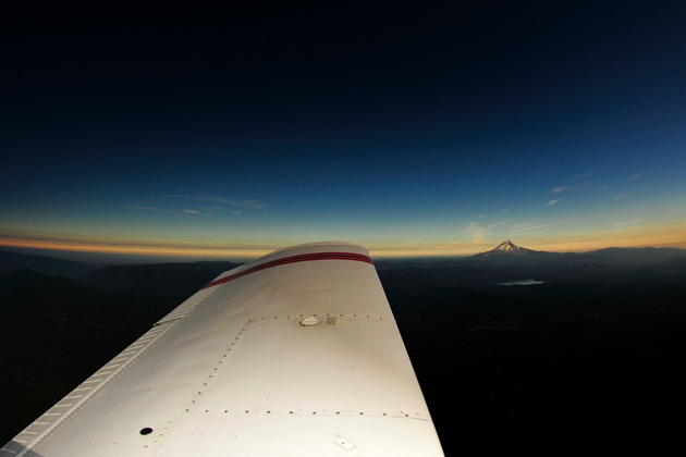 We had this exact view from our cockpit, flying in totality while looking at Mt. Hood, still in the light. Photo from another Piper in the air with us over Oregon.