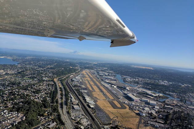 Flying with open side windows in the Icon A5 just north of Boeing Field, with Mt. Rainier in the distance. Photo by Macaela Wright.