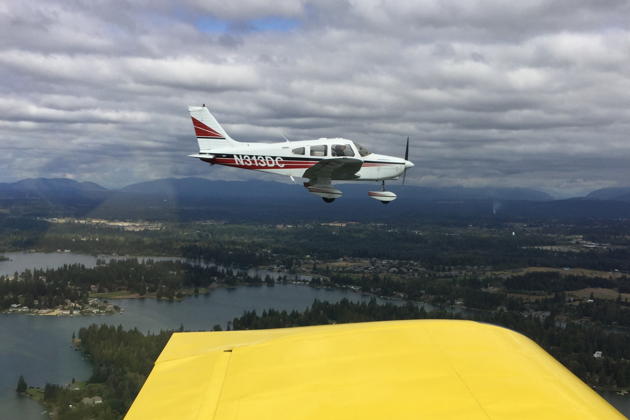 Our Warrior over Lake Tapps, in formation with the RV-7. Photo by Doug Happe.
