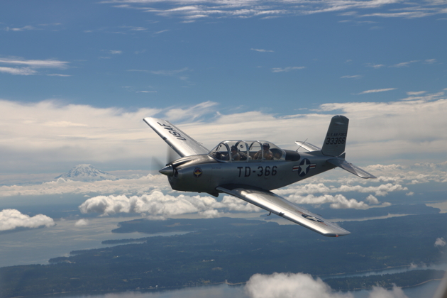 'Smiley' McColly and Jim Ostrich in T-34 over Puget Sound waterways, with Mt. Rainier in the distance.