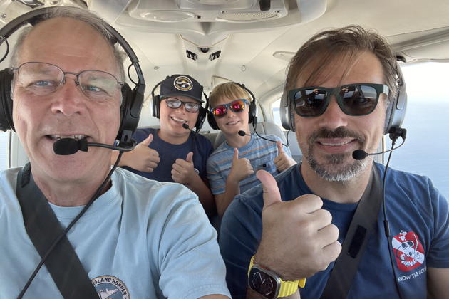 David flying as pilot-in-command for his refresher flight, with Alex and Nathaniel in the back. My photo.