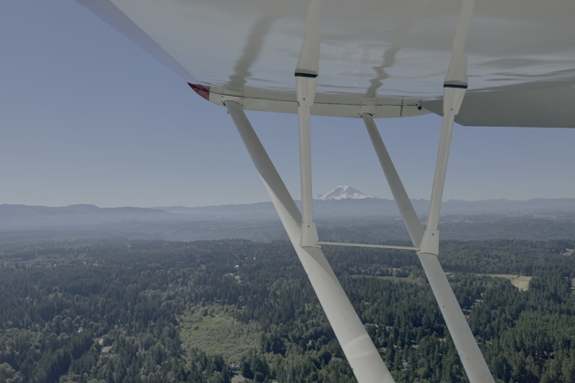 Mt. Rainier reflected in the smooth wooden wing of the Howard. My photo.