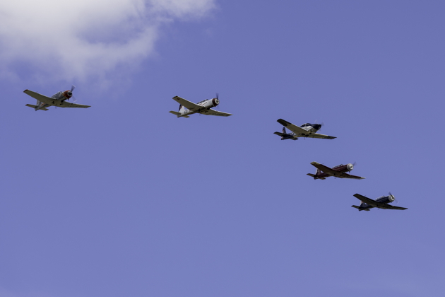 Four Canadian Nanchangs on their depature flypast, led by Roger Collins in his Navion. Photo by Dan Shoemaker.