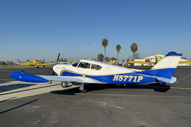 Comanche N5771P getting refueled at Tulare, CA, with a fleet of nearby cropdusters. My photo.