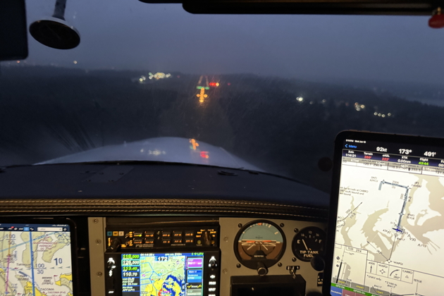 Breaking out on final for Tacoma's runway 17 after our our night RNAV approach in the Comanche. My photo.