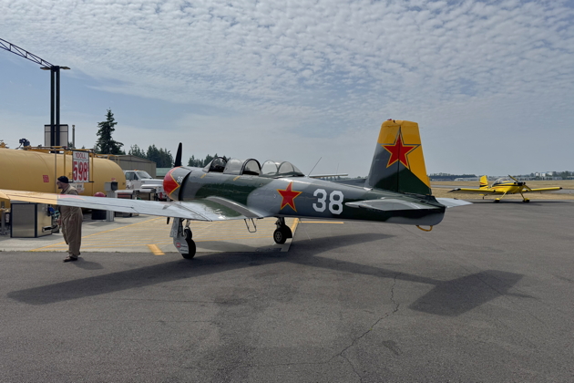 Jeff Hanoff refueling Nanchang N431DM at Arlington, with Doug Happe's RV-7 parked nearby. My photo.