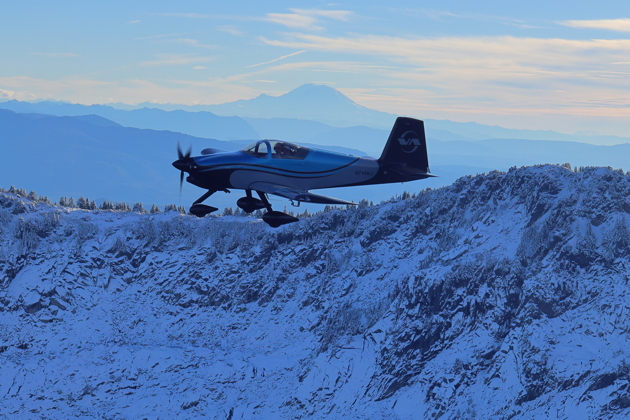 The RV-9A appearing to land on Mt. Pilchuck, with Mt. Rainier in the far distance. Photo by Dennis Jones.