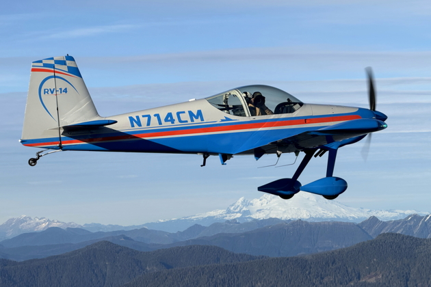 Dennis Jones using the lens hood on my camera in Mike Lambert's RV-14. Photo by Steve Dame.