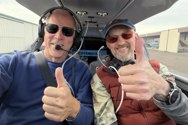 Two thumbs up with Brian Malcolm after a great formation flight in his Sling TSi. My photo.