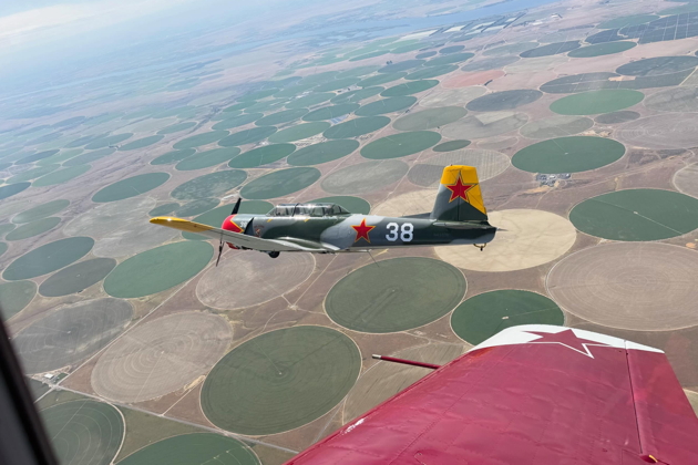 Jeff 'Spank' Hanoff's Nanchang CJ-6 N431DM 'Red Raider' over the irrigation circles of eastern Washington. Photo by Tom 'Chox' Spreen.