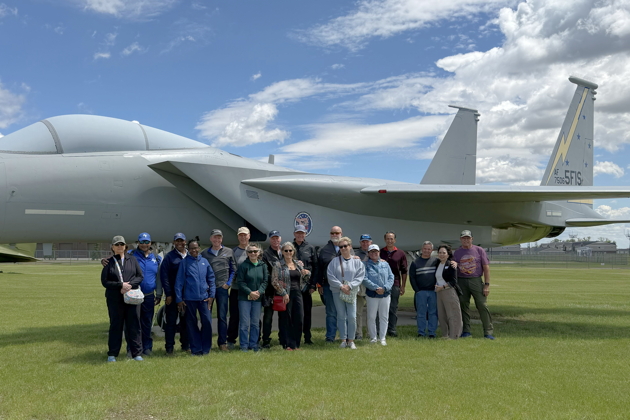 The reunion team in front of the Dakota Territory Air Museum's F-15 in 5th Fighter colors. From left to right: Linda Smith, Ken 'Homer' Smith, Daryl 'Bones' Jones, Martha Jones, Mike 'Levi' Levitt, Stan 'Sundance' Kasprzyk, Mary Kasprzyk, Jim 'Hacksaw' McComas, Lea McComas, Mike 'Pork' VanLaan, Dave 'Over' Szeles, Becky Szeles, Sean 'Sleepy' O'Brien, Coleen O’Brien, Tom 'Konscan' Konicke, Phil 'Lebeau' Nicholson, Dori Nicholson and Ralph 'Root' Moser. Alison Levitt also attended the reunion, but was visiting her Mom locally during the F-15 photo shoot.