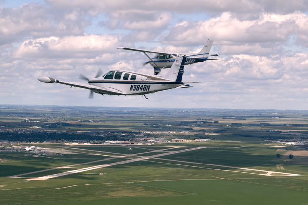 Root Moser in his 182 leading Lebeau Nicholson in his Bonanza for the 5th Fighter memorial flyby.