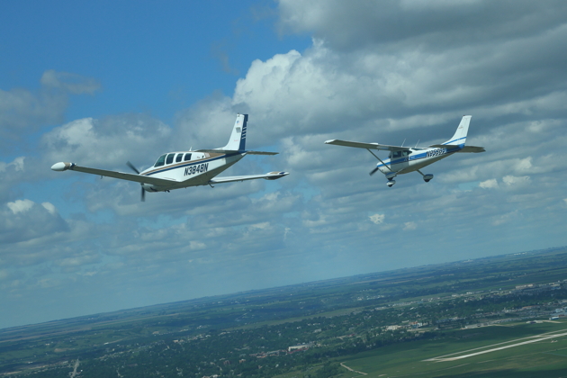 Root Moser in his 182 leading Lebeau Nicholson in his Bonanza for the 5th Fighter memorial flyby.